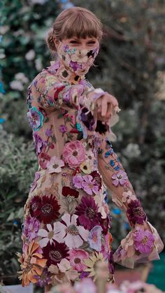 a woman in a dress with flowers on her face