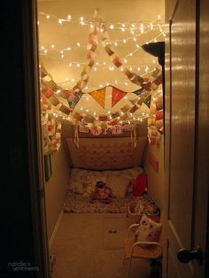 the hallway is decorated with string lights and buntings on the wall above it