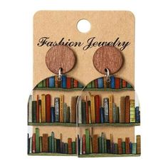 Product Description: 1. Name of product: Book earrings 2. Product size: 7.2cm (2.84in) 3. Product style: book earrings 4. Product color: as shown in the picture 5. Product material: acrylic Product features: 1. These earrings are made from actual library books, carefully crafted into a unique and stylish dangle design. 2. The earrings feature a number of neatly arranged books, making them an ideal accessory for bookworms and literature lovers. 3. The lightweight design allows for comfortable wea Acrylic Bookshelf, Lover Earrings, Library Bookshelves, Book Earrings, Book Enthusiast, Dog Books, Mors Dag, Wood Pendant, Book Nooks