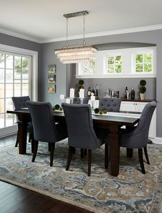 the dining room table is surrounded by gray chairs