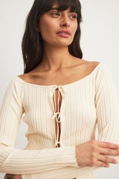 This cardigan is ribbed and fine-knit and features a fitted top. It has a stretchy material and a boat neckline. The cardigan has self tie closures down the front. Tie Cardigan, Fine Knit Cardigan, Sleepwear Sets, Fitted Top, Girls World, Business Outfit, Ribbed Knit Sweater, Winter Fits, Beige Sweater