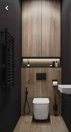 a modern bathroom with wood paneling and white fixtures on the walls, along with a toilet