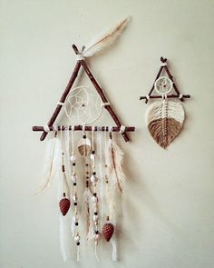 two dream catchers hanging on the wall next to each other