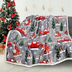 a christmas themed blanket is draped over a couch