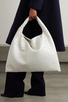 This beautifully crafted tote is undoubtedly Bottega Veneta - it's woven from strips of glossy white leather using the house's signature intrecciato technique. Defined by its slouchy shape, it's sized to hold all your essentials and has a curved shoulder strap. Luxury White Shoulder Bag With Intrecciato Weave, Luxury White Intrecciato Weave Shoulder Bag, Designer White Bags With Intrecciato Weave, Designer White Shoulder Bag With Braided Handles, White Structured Leather Bag, White Rectangular Bag With Intrecciato Weave, Luxury White Woven Leather Shoulder Bag, Designer White Shoulder Bag With Woven Leather, White Top Handle Bag With Intrecciato Weave