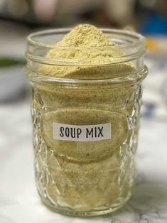 a jar filled with soup mix sitting on top of a table