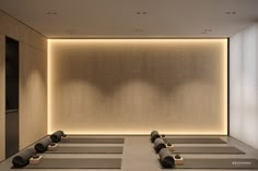 an empty room with yoga mats and lights