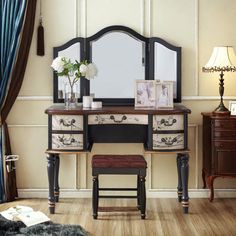 a dressing table with mirror and stool in a room