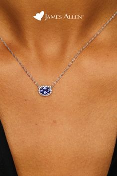 Celebrate a classic look with this necklace featuring an east-west set tanzanite oval surrounded by a halo of diamonds and a signature clasp for a perfect adjustable fit | James Allen Necklace Style: 8340727W14 | #diamondpendant #diamond #diamonds #diamondjewelry #diamondnecklace #diamondring #jewelry #diamondearrings #jewellery #pendant #diamondjewellery #finejewelry #jewellerydesign #whitegold #fashion #gemstone #jamesallen Diamond Halo Necklace, Oval Tanzanite Halo Jewelry, Oval Tanzanite Jewelry With Gemstone Accents, Engagement Rings And Wedding Band, Necklace With Name, Bold Statement Jewelry, Tanzanite Pendant, Jewellery Pendant, Tanzanite Necklace