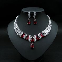 Hand-set Cubic Zirconia Party Sets, Elegant Cubic Zirconia Party Sets, Festive Cubic Zirconia Jewelry Sets For Wedding, Silver Crystal Wedding Sets, Festive Wedding Jewelry Sets With Cubic Zirconia, Silver Crystal Sets For Wedding, Elegant Ruby Bridal Set For Wedding, Elegant Red Jewelry Sets For Party, Red Bridal Necklace For Party