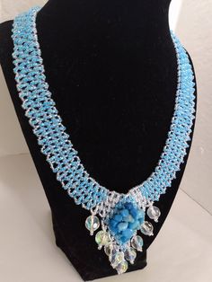 A handmade glass beaded necklace that is perfect for any occasion: parties, holidays, birthdays, anniversaries. All products are hand-crafted by my mother. Dimensions: - Length: 28.5 cm - Width: 22 cm Lightweight, high quality with a beaded hook as a clasp.  Acrylic Pearls: 8 mm. Will respond to concerns and suggestions promptly. Shipping costs: Free Domestic Shipping. All orders are sent by air-mail with tracking number. Time of delivery: Estimated 1-3 days for domestic shipping; international Handmade Round Crystal Beaded Necklaces, Handmade Crystal Beaded Necklaces, Handmade Round Crystal Necklace, Handmade Beaded Necklaces For Celebration, Crystal Beaded Necklaces As Gift, Turquoise Beaded Jewelry For Celebration, Glass Beaded Jewelry For Crafting, Handmade Turquoise Necklaces For Weddings, Crystal Beaded Chain Necklaces For Gift