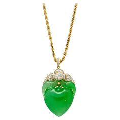 Discover a symbol of love and elegance with this Jadeite Jade pendant necklace. Crafted in 18K Yellow Gold, this exquisite piece showcases a heart-shaped carved green jade pendant, displaying a wonderful two-bird feeding motif carving. Symbolic of two entities coming together to form one. The pendant is adorned with channel set baguette and round-cut diamonds. With an 18 inch rope chain necklace, this piece rests beautifully around the neck, ensuring a comfortable fit. Item Details: - Type: Pendant Necklace - Metal: 18K Yellow Gold - Weight: 30 Grams - Setting: Channel, Bezel - Size: 18 inches - Pendant: 5.5 x 3.25 cm Center Stone Details: - Type: Jade - Shape: Heart, Carved Bird motif - Color: Green - Measurements: 35 x 32 mm Side Stone Details: - Type: Diamond - Cut: Round - Quantity: 30 Asian Art Deco, Jade Pendant Necklace, Bird Feeding, Carved Heart, Bird Motif, Crown Jewels, Channel Set, Jade Pendant, Green Jade