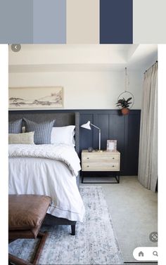 a bedroom with blue and white colors in the walls, carpeted flooring and an upholstered bed