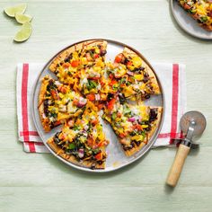 a pizza sitting on top of a pan covered in toppings next to a spatula