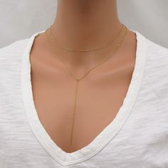 REAL GOLD-FILLED NECKLACE SET This lariat necklace set is made with all gold-filled parts (not plated) so it will be durable and tarnish resistant. Includes both necklaces pictured - can be worn together or separately. The drop chain of the lariat measures approximately 4 inches long. Please leave a note at checkout if you want this changed. Both necklaces close with a spring-ring clasp. Sterling silver version here: www.etsy.com/listing/763096037/sterling-silver-lariat-necklace-layering SIZING - PLEASE READ: Note that necklaces will fit differently depending on a person's size. Please measure. ABOUT GOLD FILLED JEWELRY: This quality piece is made with real gold filled, not plated. Gold-filled jewelry has 100x more gold alloy than gold plated and because that layer is so much thicker, it m Gold Layered Dangle Necklace With Adjustable Chain, Gold Plated Delicate Chain Lariat Necklace, Gold Layered Necklace With Adjustable Chain And Dangle, 14k Gold Filled Layered Necklace With Adjustable Chain, Gold Long Necklace For Layering, Gold Choker Drop Necklace With Clavicle Chain, Gold Dangle Chain Necklace For Layering, Adjustable Gold Necklaces For Layering, Adjustable Gold Necklace For Layering