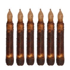 five brown candles with burnt edges are lined up in a row on a white background