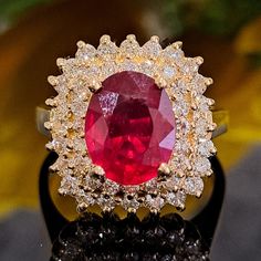 This Ruby is authentic as they are grown in a lab environment. 3.75 Carat Lab-created Ruby & Natural Diamonds 14k Solid Yellow Gold Ring Ring Material: 14k Solid Gold Approximate Weight: 5.8 Grams Band Width about 2.0 mm Gemstone: Lab-created Ruby Gemstone Color: Red Gemstone Clarity: Moderately Included Gemstone Shape: Oval Gemstone Dimensions are about: 9.70x7.90 mm Gemstone Carat Weight about: 2.80 Carat Gemstone Quantity: 1 Diamonds: Natural Round Shaped Diamonds Color: G Diamonds Clarity: S Gia Certified Oval Ruby Ring, Dazzling Oval Ruby Ring With Diamonds, Luxury Oval Ruby Ring With Halo Design, Oval Ruby Ring With Vvs Clarity Diamond, Oval Ruby Ring With Diamond Center Stone, Oval Ruby Ring With Diamond, Oval Lab-created Ruby Ring With Center Stone, Classic Gia Certified Diamond Ring With Lab-created Ruby, Exquisite Oval Ruby Ring Gia Certified