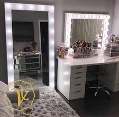 a vanity with lights and makeup on it