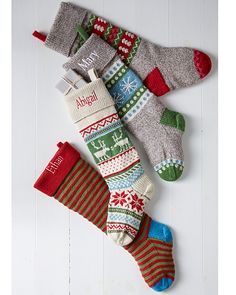 three pairs of christmas socks laying next to each other