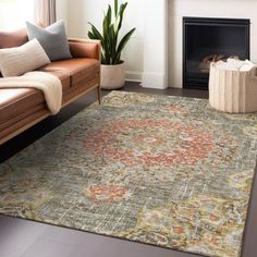 a living room area with a couch, chair and rug in front of a fireplace