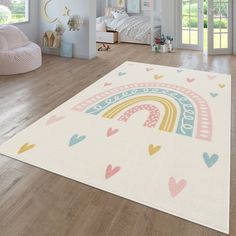 a child's room with a rainbow rug on the floor