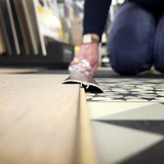 a person is using a knife to cut through the floor