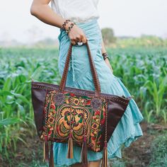 "This shoulder bag is the perfect addition to enhance your offerings. It features a tribal hmong pattern, cotton lining, adorned with black leather tassel as decoration. This shoulder bag will highlight your fabulous offerings. We buy materials from Hmong market and we design and sew by hand. Some of the bags we modify to improve the product. The Hmong tribes live in the North of Thailand and have origins from the Tibetan area of China. You may not receive the exact bag picture here, As the fabr Handmade Multicolor Embroidered Hobo Bag For Everyday Use, Embroidered Rectangular Hobo Bag For Festivals, Handmade Multicolor Embroidery Hobo Bag For Everyday Use, Traditional Multicolor Shoulder Bag With Removable Pouch, Handmade Multicolor Embroidery Hobo Bag, Handmade Multicolor Embroidered Tote Shoulder Bag, Hand-stitched Rectangular Bag With Multicolor Embroidery, Hand-stitched Multicolor Embroidery Festival Bags, Embroidered Satchel Hobo Bag For Daily Use