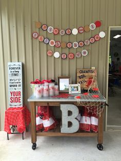 a table that has some items on it and is decorated with red and white decorations