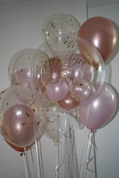 a bunch of pink and gold balloons with the words happy birthday written on one balloon