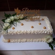 a wedding cake with white flowers and gold decorations