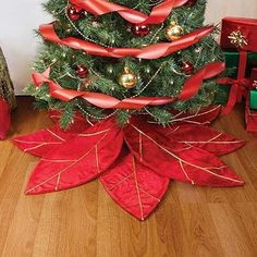 a christmas tree decorated with red ribbon and ornaments