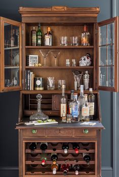 an old fashioned liquor cabinet filled with bottles and glasses