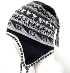 Black Unisex Peruvian Alpaca Hat chullo with Earflaps 100% Lining, Soft Fleece Lining Beanie hat, alpaca chullo peruvian hat, peru hat, alpaca hat Alpaca blended wool - High Quality - 100% Lining This is a brand new one of a kind chullo hat made of alpaca, one of the finest yarns in the world. It is soft and warm and features an exquisite intarsia design in a gorgeous color combination. Color combinations are unique due to the handcrafted nature of the product. Order is by main color. Alpaca is Alpaca Hat For Outdoor Winter Use, Traditional Beanie Hats For Winter, Traditional Beanie For Winter, Traditional Warm Adjustable Hats, Traditional Warm Hats With Adjustable Fit, Alpaca Winter Hat For Cold Weather, Winter Alpaca Hat For Cold Weather, Adjustable Alpaca Hat For Outdoor, Traditional Winter Hats With Ear Flaps