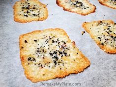 crackers with black seeds on them sitting on a baking sheet