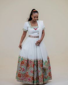 Description Indulge in the epitome of elegance with our breathtaking Habesha Kemis, a fusion of tradition and contemporary style. Our Habesha dress exudes timeless beauty and sophistication, adorned with intricate patterns that capture the essence of Ethiopian culture. Step into luxury and grace with this gorgeous, stylish Ethiopian dress, crafted to make every moment unforgettable. Material Cotton Menen Thread Estimated delivery : 3 weeks to 5 weeks Contact WhatsApp +1(304)-306-2784Email: conta Traditional Drape Cutdana Dress For Reception, Traditional Wedding Gown With Traditional Patterns, Elegant White Choli For Navratri, Festive Embroidered Wedding Dress, Transitional Season White Floor-length Sets, Floor-length Gown With Traditional Patterns For Ceremonies, Fitted Dresses For Diwali Ceremonies, Traditional Wedding Dress For Ceremonies, Traditional Gown With Patterns For Ceremonies