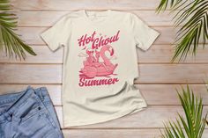 This summer celebrate with this spooky "Hot Ghoul Summer" tee. Features a cute skeleton on a pool flamingo float drinking lemonade. This spooky summer tee is perfect for summerween or Halloween. Celebrate the spooky vibes all summer long with this tee. This Hot Ghoul Summer tee makes a great gift idea for any Spooky Witch, Spooky Mama, Spooky Mimi, and anyone who loves spooky vibes. This summer costume also great for Family Vacation summer trips, pool days and a day at the beach.  *PROCESSING TI Novelty Cotton Tops For Summer, Novelty Screen Print Tops For Summer, Band Merch Shirt With Screen Print For Summer, Novelty Screen Print Summer Tops, Band Merch Screen Print Shirt For Summer, Summer Band Merch Shirt With Screen Print, Fun Summer Streetwear Shirt, Novelty Graphic Print Shirt For Summer, Summer Skull Print Shirt For Streetwear