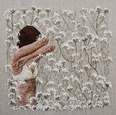 a woman with her back to the camera, in front of white flowers and branches