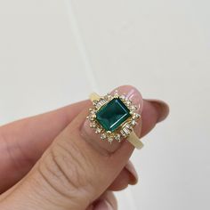 Estate/ vintage 14KT yellow gold lab-created, emerald-cut emerald with surrounding, baguette + round diamonds halo ring. Would make a fantastic emerald engagement ring or just an added ring to your collection! Size 6.25 Can be resized for an additional fee Lab Emerald 1.85~2.00+CTW Emerald-cut emerald measures: 8mm x 5mm Round (14) round natural diamonds; SI clarity; H color, (6) natural, baguette diamonds; VSI clarity; H color Stamped 14K Weight: 3.40 grams Excellent estate condition Rings 2023, Vintage Emerald Engagement Ring, Ballerina Ring, Round Diamond Halo, Deco Rings, Emerald Ring Vintage, Emerald Ring Gold, Baguette Diamonds, Sparkling Rings