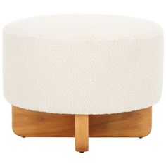 a white ottoman sitting on top of a wooden stand