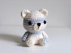 a small crocheted teddy bear sitting on top of a table