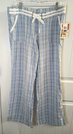 These JOLT women's pants are a stylish addition to your wardrobe. The blue striped linen blend fabric has a tasseled drawstring closure and wide-leg style that is perfect for a casual beachy look. The pants come with pockets and are machine washable for easy care. Ideal for summer and spring, these pants are available in a regular size with a waist of 35 inches and inseam of 31 inches. The flat front and low-rise waist make it comfortable and flattering for any body type. Perfect for a day at th Cotton Wide Leg Pants For Beach Season, Cotton Wide Leg Pants With Pockets For Beach, Striped Bottoms With Pockets For Beach Season, Blue Wide Leg Beach Pants With Pockets, Striped Beach Pants With Pockets, Blue Wide Leg Pants For Beach With Pockets, Blue Wide Leg Pants With Pockets For Beach, Striped Wide-leg Beach Bottoms, Striped Wide Leg Pants With Elastic Waistband For Vacation