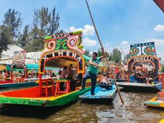 people are on colorful boats in the water