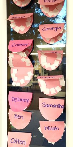 a bulletin board with pink paper cutouts and words on it that spell out the names of different countries