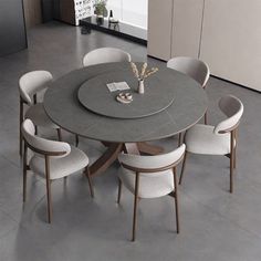 a round table with six chairs around it