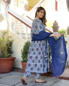 This is a stunning angrakha style 3 piece set. It comes with a blue block printed kurta with 3/4th sleeves. The kurta is paired with a pair of printed semi elasticated ankle length palazzo pants and a contrast dupatta to match. Color-Blue & White Work-Print Work Suit Fabric-Cotton Dupatta Fabric-Mulmul Neck-V Neck Work-Print work with white lace detailing Length-Calf Length Care-Hand Wash or Dry Clean Eid Indigo Kurta With Dupatta, Indigo Kurta With Dupatta For Eid, Eid Special Indigo Kurta With Dupatta, Indigo Straight Kurta With Dabka, Traditional Indigo Sets With Dupatta, Indigo Dabka Straight Kurta, Blue Straight Kurta With Dupatta, Indigo Sets With Dupatta For Navratri, Indigo Navratri Set With Dupatta