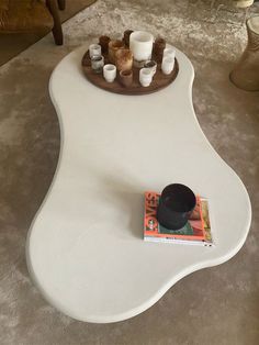 a coffee table with candles and a magazine on it