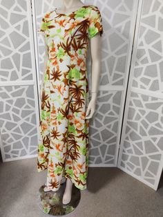 This is another Hawaiian dress from my collection that I'm listing. This dress is by Pomare of Hawaii in a striking hibiscus and palm tree print in colours of lime green apricot and chocolate brown. The maxi dress features a waterfall back which is a large pleat on either side of the long nylon zipper, has a scooped neckline and seamed fitted bodice and a flared maxi length. The condition is very good Best fit is a medium size 12au Measurements are Shoulder to shoulder Bust 100cm Waist 86cm Leng Tropical Short Sleeve Printed Maxi Dress, Tropical Floral Print Short Sleeve Maxi Dress, Tropical Floral Print Maxi Dress With Short Sleeves, Tropical Printed Maxi Dress With Short Sleeves, Fitted Hawaiian Dress With Tropical Print, Brown Maxi Dress For Beach Season, Tropical Style Short Sleeve Maxi Dress With Tropical Print, Tropical Short Sleeve Maxi Dress With Tropical Print, Green Hawaiian Maxi Dress For Spring