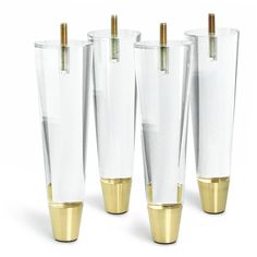 four tall clear vases with gold rimmed bases