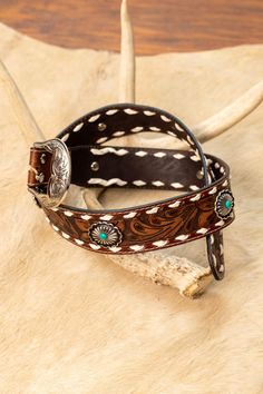 Expertly crafted and hand-tooled, the Outlaw Trail Belt is made from 100% genuine leather. Adorned with a classic leaf pattern, faux silver conchos with faux turquoise detailing, and buck stitch accents, this western accessory is a must-have for any stylish outfit. With a removable buckle, this belt offers both functionality and fashion. Wider Width: 1 3/4" Small: 36" Medium: 40" Large: 44.5" XL: 48" Hand Tooled Brown Jewelry For Rodeo, Brown Hand Tooled Jewelry For Rodeo, Western Leather Jewelry With Concho, Western Hand-tooled Leather Jewelry, Western Brown Hand-tooled Jewelry, Western Style Hand-tooled Leather Jewelry, Casual Country Outfits, The Outlaw, Western Accessories