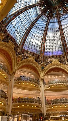 the inside of a large building with many glass domes and chandeliers on it